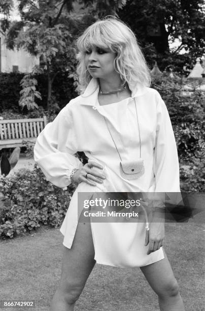 Model wearing 1977 clothing, Sunday Mirror fashion feature, pictured in garden, 2nd August 1977, picture shows model Jo Wood.