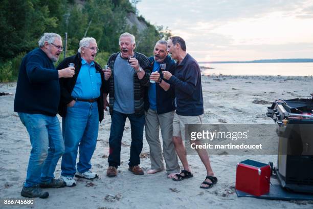 Five seniors brothers goofing around at happy hour on the beach