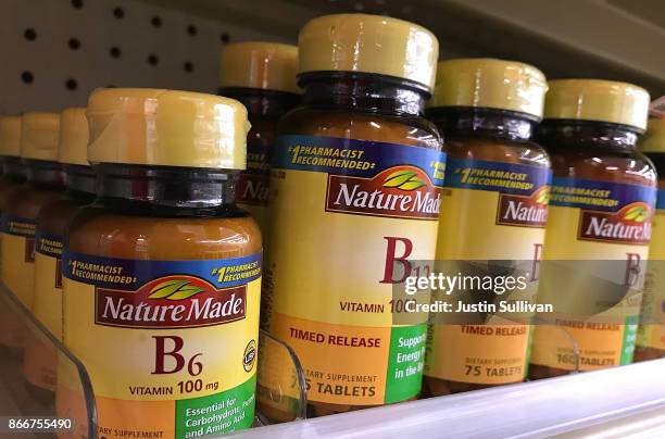 Bottles of vitamins B6 and B12 are displayed on a shelf at a CVS store on October 26, 2017 in San Anselmo, California. According to a report in the...