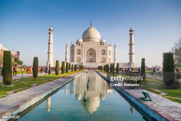people visiting the magnificent taj mahal in agra. - reflection water india stock pictures, royalty-free photos & images