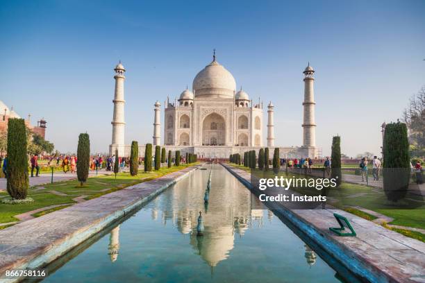people visiting the magnificent taj mahal in agra. - agra stock pictures, royalty-free photos & images