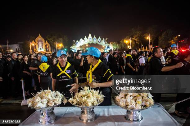 Volunteers prepare sandalwood flowers during the cremation ceremony of the late King Bhumibol Adulyadej at the Royal Plaza in Bangkok, Thailand, on...