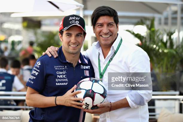 Sergio Perez of Mexico and Force India meets Chilean football legend Ivan Zamorano in the Paddock during previews to the Formula One Grand Prix of...