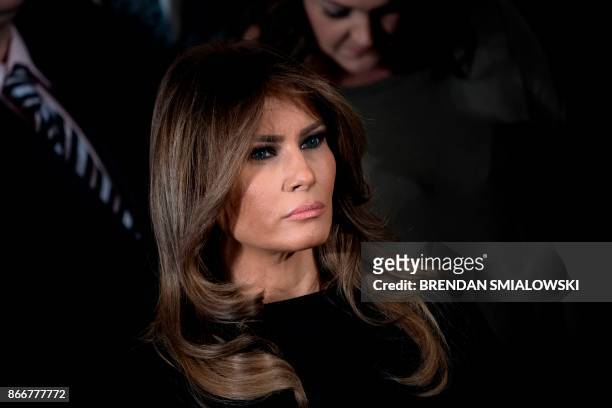 First lady Melania Trump listens to the US president deliver remarks on combatting drug demand and the opioid crisis on October 26, 2017 in the East...