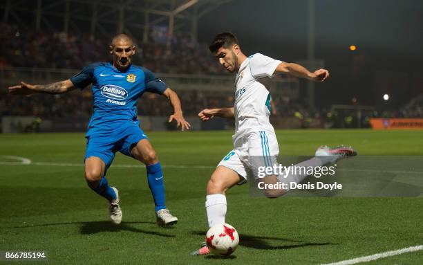 Marco Asensio of Real Madrid CF cross the ball past Cata Diaz of Fuenlabrada during the Copa del Rey, Round of 32, First Leg match between...