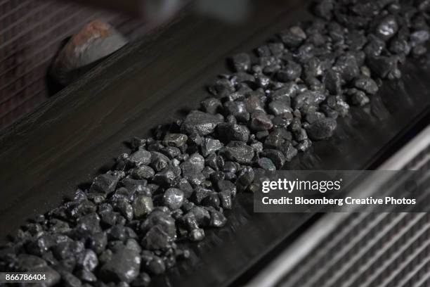 copper-nickel ore moves along a conveyor belt - metallic belt stock pictures, royalty-free photos & images