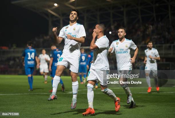 Marco Asensio of Real Madrid CF celebrates with teammates after scoring his teamÕs opening goal from a penalty kick during the Copa del Rey, Round of...