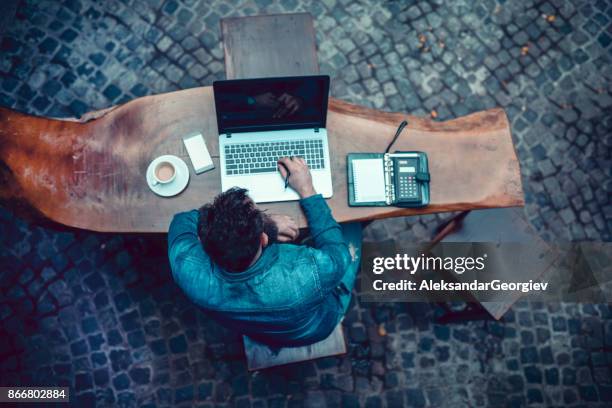 overworked bearded hipster freelancer working at his favorite cafe - one man only business stock pictures, royalty-free photos & images