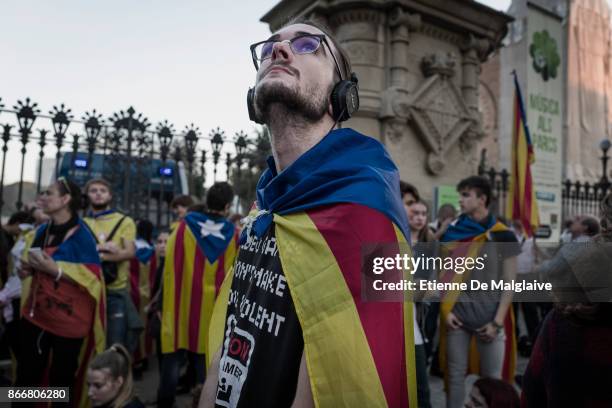 Independence supporters gather at one gate of the closed Parliament's park as the Catalan Parliament is on session to debate on the 155 article...