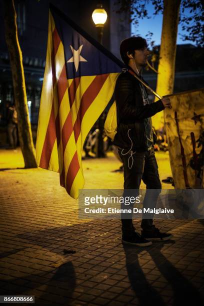 Independence supporters gather at one gate of the closed Parliament's park as the Catalan Parliament is on session to debate on the 155 article...