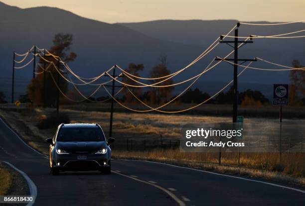 Motorist makes their way up highway 145 just out of Redvale Colorado paralleling power lines from the nearby Tri-State Generation and Transmission...