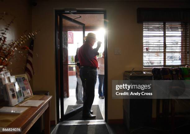 Reed Mitchell, Owner of the Rimrock Hotel in Naturita Colorado, stops in the doorway to talk to customers of the hotel October 19, 2017. Reed employs...