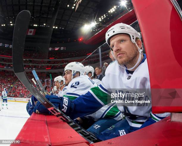 Derek Dorsett of the Vancouver Canucks watches the action from the bench Detroit Red Wings during an NHL game at Little Caesars Arena on October 22,...