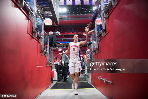 Henry Ellenson of the Detroit Pistons gives high five to a fan during the game against the Minnesota Timberwolves on October 25, 2017 at Little...