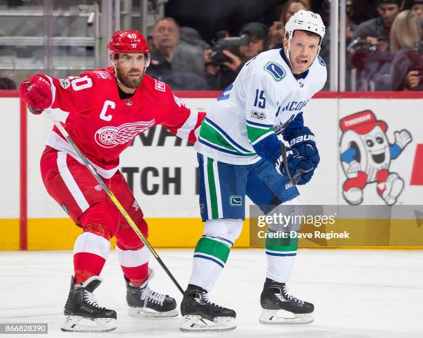 Henrik Zetterberg of the Detroit Red Wings stays close to Derek Dorsett of the Vancouver Canucks during an NHL game at Little Caesars Arena on...