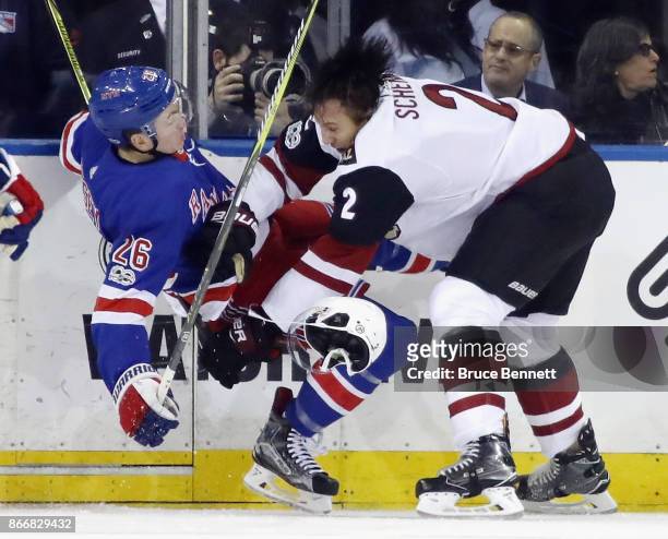 Jimmy Vesey of the New York Rangers is checked by Luke Schenn of the Arizona Coyotes during the first period at Madison Square Garden on October 26,...