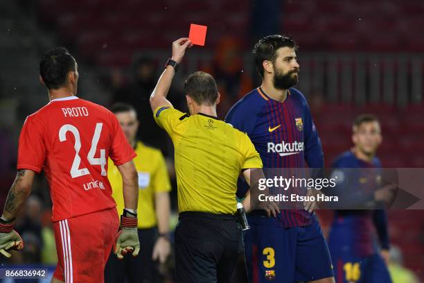 Gerard Pique of Barcelona is shown the red card of the match by referee William Collum during the UEFA Champions League group D match between FC...