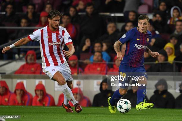 Lucas Digne of Barcelona and Guillaume Gillet of Olympiakos compete for the ball during the UEFA Champions League group D match between FC Barcelona...