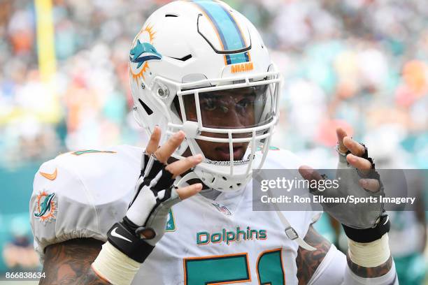 Mike Pouncey of the Miami Dolphins looks on during a NFL game against the New York Jets at Hard Rock Stadium on October 22, 2017 in Miami Gardens,...