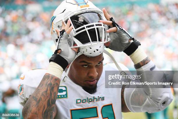 Mike Pouncey of the Miami Dolphins looks on during a NFL game against the New York Jets at Hard Rock Stadium on October 22, 2017 in Miami Gardens,...