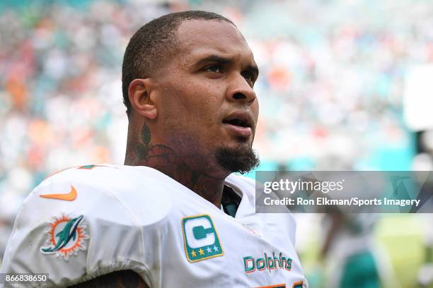 Mike Pouncey of the Miami Dolphins looks on during a NFL game against the New York Jets at Hard Rock Stadium on October 22, 2017 in Miami Gardens,...