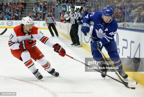 Toronto Maple Leafs defenseman Morgan Rielly moves the puck in the offensive end as Carolina Hurricanes defenseman Justin Faulk keeps close. Toronto...