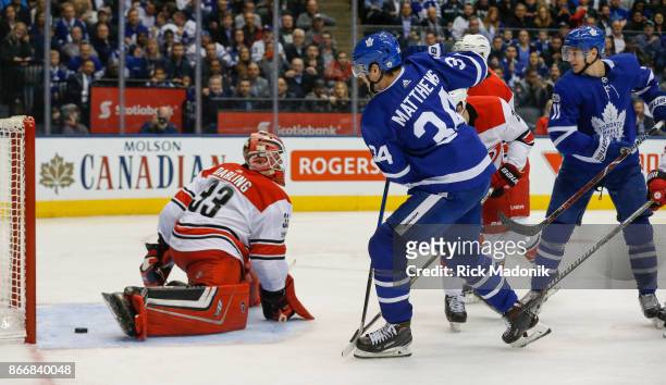 Toronto Maple Leafs center Zach Hyman slips one past Carolina Hurricanes goalie Scott Darling as Toronto Maple Leafs center Auston Matthews watches...