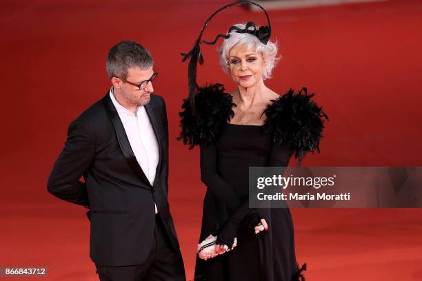 Marina Ripa di Meana and a guest walk a red carpet for 'Hostiles' during the 12th Rome Film Fest at Auditorium Parco Della Musica on October 26, 2017...