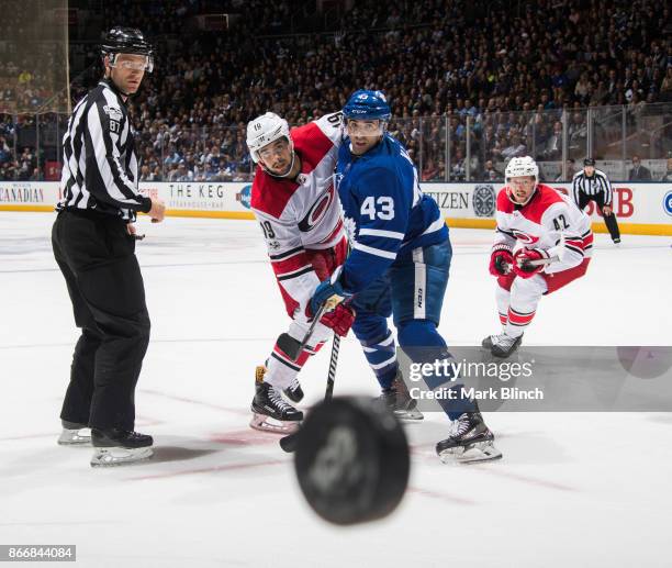 Josh Jooris of the Carolina Hurricanes and Nazem Kadri of the Toronto Maple Leafs battle for the puck during the second period at the Air Canada...