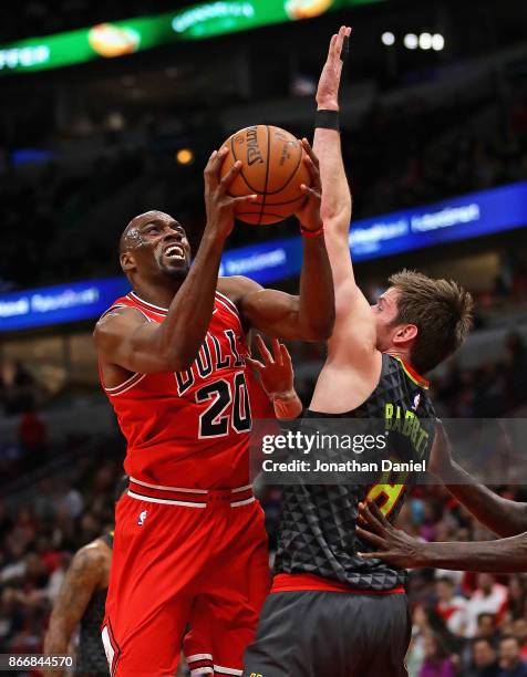 Quincy Pondexter of the Chicago Bulls tries to get off a shot against Luke Babbitt of the Atlanta Hawks at the United Center on October 26, 2017 in...