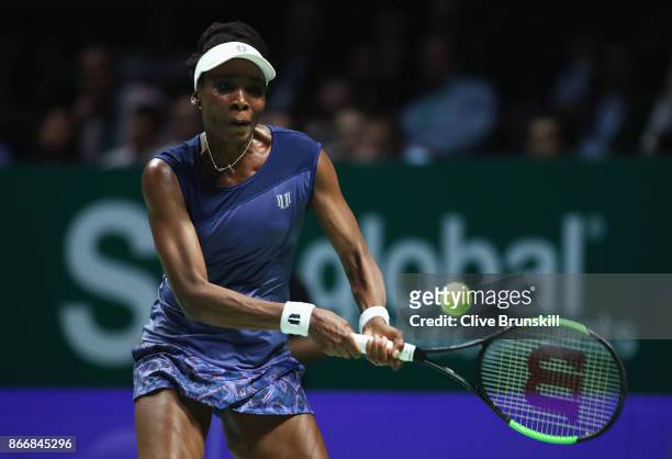 Venus Williams of the United States plays a backhand in her singles match against Garbine Muguruza of Spain during day 5 of the BNP Paribas WTA...