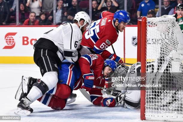 Jake Muzzin of the Los Angeles Kings pushes Phillip Danault of the Montreal Canadiens into goaltender Jonathan Quick during the NHL game at the Bell...