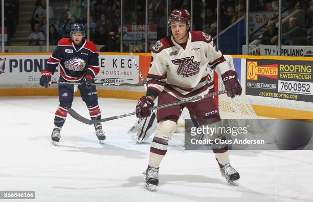 Cole Fraser of the Peterborough Petes defends against the Saginaw Spirit in an OHL game at the Peterborough Memorial Centre on October 26, 2017 in...