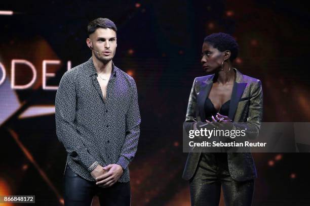 Model Baptiste Giabiconi and host Nikeata Thompson speak on stage at the New Body Award By McFit Models on October 26, 2017 in Berlin, Germany.