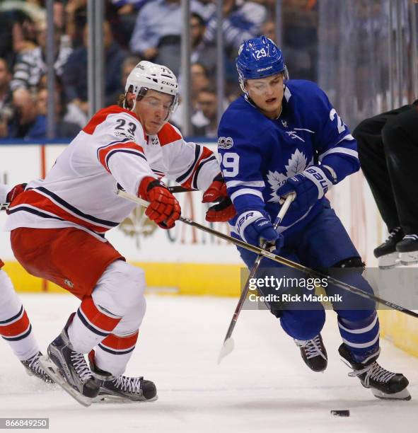 Toronto Maple Leafs center William Nylander chases the puck as Carolina Hurricanes left wing Brock McGinn keeps close. Toronto Maple Leafs VS...