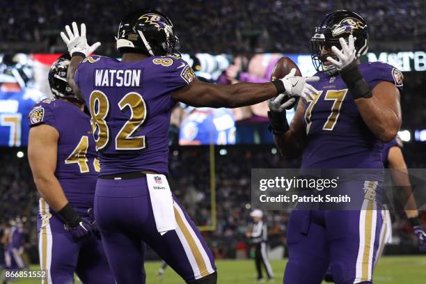 Tight End Benjamin Watson, full back Patrick Ricard and offensive tackle Austin Howard of the Baltimore Ravens celebrate after a touchdown in the...