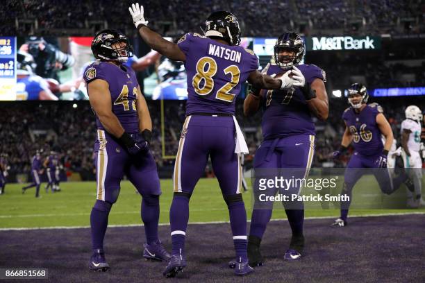 Tight End Benjamin Watson, full back Patrick Ricard and offensive tackle Austin Howard of the Baltimore Ravens celebrate after a touchdown in the...