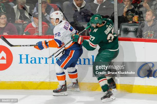 Kyle Quincey of the Minnesota Wild defends Anthony Beauvillier of the New York Islanders during the game at the Xcel Energy Center on October 26,...