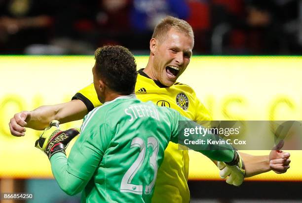 Adam Jahn of Columbus Crew reacts with goalkeeper Zack Steffen after converting a penalty kick to give the Crew a win over the Atlanta United 3-1 on...