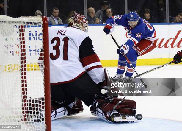Adin Hill of the Arizona Coyotes makes the toe save on Rick Nash of the New York Rangers who was playing in his 1000th NHL game skates against the...
