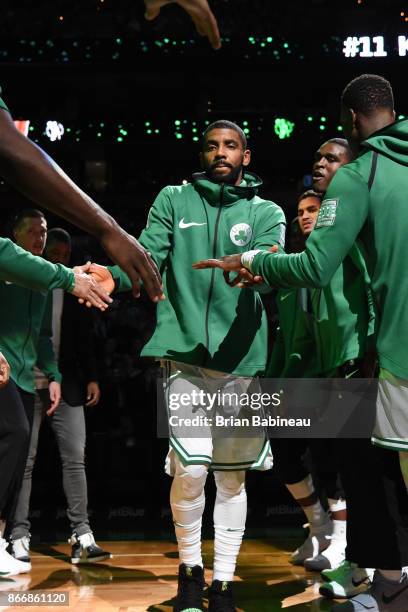 Kyrie Irving of the Boston Celtics high fives teammates during introductions before the game against the New York Knicks on October 24, 2017 at the...