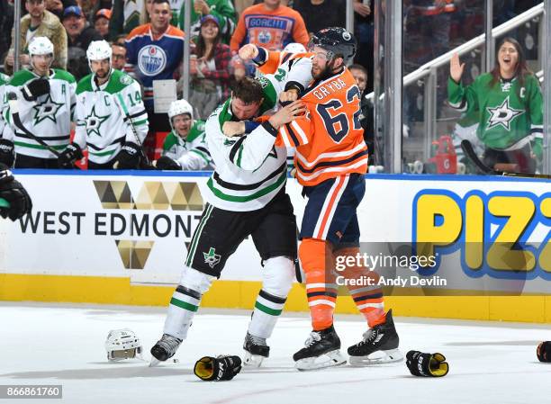 Eric Gryba of the Edmonton Oilers fights with Antoine Roussel of the Dallas Stars on October 26, 2017 at Rogers Place in Edmonton, Alberta, Canada.