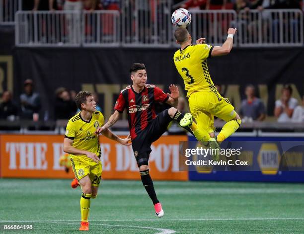 Josh Williams of Columbus Crew wins a header against Miguel Almiron of Atlanta United during the Eastern Conference knockout round at Mercedes-Benz...