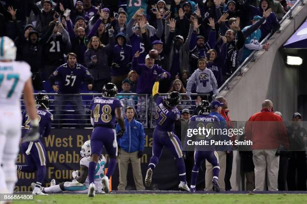 Inside Linebacker C.J. Mosley of the Baltimore Ravens celebrates after a touchdown in the fourth quarter against the Miami Dolphins at M&T Bank...