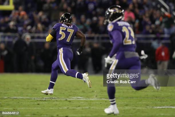 Inside Linebacker C.J. Mosley of the Baltimore Ravens runs back an interception for a touchdown in the fourth quarter against the Miami Dolphins at...
