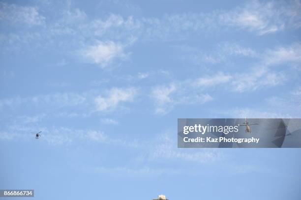 Police helicopters hover as protesters gather in the city centre to demonstrate against the Spanish federal government's move to suspend Catalonian...