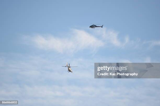 Police helicopters hover as protesters gather in the city centre to demonstrate against the Spanish federal government's move to suspend Catalonian...