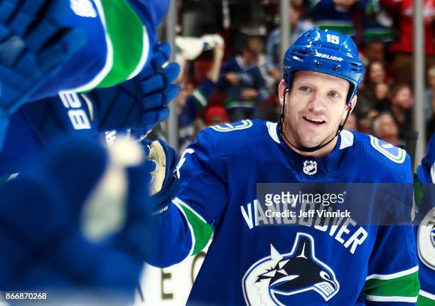 Derek Dorsett of the Vancouver Canucks is congratulated by teammates after scoring during their NHL game against the Washington Capitals at Rogers...