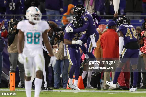 Cornerback Jimmy Smith and free safety Eric Weddle of the Baltimore Ravens celebrate after a touchdown in the fourth quarter against the Miami...