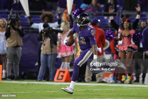 Cornerback Jimmy Smith of the Baltimore Ravens runs back an interception for a touchdown in the fourth quarter against the Miami Dolphins at M&T Bank...